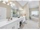 Bright bathroom with double sinks, vanity, large mirrors, tile floor, and separate tub and shower at 1297 Hadaway Trl, Lawrenceville, GA 30043