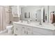 The bathroom features a double sink vanity, shower over tub, and decorative lighting at 1297 Hadaway Trl, Lawrenceville, GA 30043