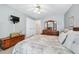This bedroom is spacious, with a ceiling fan, neutral paint, carpet flooring, and a TV at 1297 Hadaway Trl, Lawrenceville, GA 30043