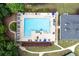 Aerial view of a large community pool with lounge chairs, umbrellas, and well-maintained landscaping at 1297 Hadaway Trl, Lawrenceville, GA 30043