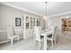 Cozy dining room featuring neutral walls, carpet floors, and a stylish chandelier fixture at 1297 Hadaway Trl, Lawrenceville, GA 30043