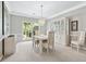 Elegant dining room featuring neutral walls, carpet floors, and a stylish chandelier fixture at 1297 Hadaway Trl, Lawrenceville, GA 30043