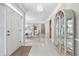 Bright foyer with marble tile floors, a chandelier, and an open view of the adjacent dining room at 1297 Hadaway Trl, Lawrenceville, GA 30043