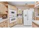 Well-equipped kitchen features bright cabinetry, white appliances, and ample counter space at 1297 Hadaway Trl, Lawrenceville, GA 30043