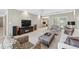 Spacious living room with tray ceiling, fireplace, and sliding doors to the outdoor patio at 1297 Hadaway Trl, Lawrenceville, GA 30043