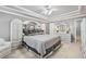 A spacious main bedroom featuring decorative tray ceilings and a luxurious bed at 1297 Hadaway Trl, Lawrenceville, GA 30043