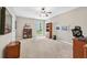 Home office featuring neutral walls, carpet flooring, a window, and custom built-in bookcases at 1297 Hadaway Trl, Lawrenceville, GA 30043