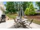 Great patio featuring dining table, chairs, BBQ grill and lush backyard at 1297 Hadaway Trl, Lawrenceville, GA 30043