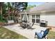 Enjoy outdoor dining on this patio with a grill, dining table, chairs, and swing bench at 1297 Hadaway Trl, Lawrenceville, GA 30043