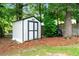 Backyard view of storage shed surrounded by mature trees at 1297 Hadaway Trl, Lawrenceville, GA 30043