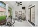 Relaxing sunroom featuring comfortable seating, a ceiling fan, and views of the backyard at 1297 Hadaway Trl, Lawrenceville, GA 30043