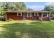 Exterior backyard view with a expansive lawn and mature trees surrounding the property at 3953 Dalhouise Ln, Decatur, GA 30034