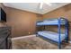 Bedroom with a ceiling fan, mounted TV, and blue bunk beds at 3953 Dalhouise Ln, Decatur, GA 30034