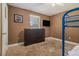 Bedroom featuring a wall-mounted TV, carpet flooring, and a window with blinds at 3953 Dalhouise Ln, Decatur, GA 30034