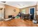 Open dining area with hardwood floors, featuring a ceiling fan and access to other rooms at 3953 Dalhouise Ln, Decatur, GA 30034