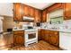 Traditional kitchen with white appliances and wooden cabinets at 3953 Dalhouise Ln, Decatur, GA 30034