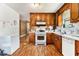 Kitchen featuring dated cabinets and appliances, and vinyl flooring at 3953 Dalhouise Ln, Decatur, GA 30034