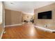 Spacious living room featuring hardwood floors, neutral paint colors, and a large flat screen tv at 3953 Dalhouise Ln, Decatur, GA 30034