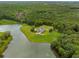Expansive estate nestled by a serene lake, showcasing luxurious living and lush greenery at 833 Hines Rd, Moreland, GA 30259