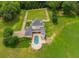 Sweeping aerial shot highlighting the home's luxurious pool area and manicured gardens at 833 Hines Rd, Moreland, GA 30259