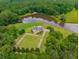 Lush landscape features a picturesque pond and well-maintained grounds from above at 833 Hines Rd, Moreland, GA 30259