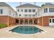 Expansive backyard with a sparkling pool, patio, and brick accents, offering a private and luxurious outdoor space at 833 Hines Rd, Moreland, GA 30259