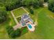 Aerial view of this home showcases the pool and backyard patio with plentiful greenery at 833 Hines Rd, Moreland, GA 30259