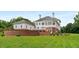 Spacious backyard featuring brick accents and a luxurious white exterior, perfect for outdoor entertaining at 833 Hines Rd, Moreland, GA 30259