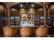 Custom bar area with ornate wood details and lighting to display glassware and spirits at 833 Hines Rd, Moreland, GA 30259