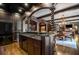 The wet bar features a copper sink, dark countertops, beverage fridge, and an open floorplan at 833 Hines Rd, Moreland, GA 30259