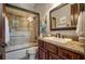 Bathroom with a shower and bathtub combo, granite countertop, wood cabinets, and decorative mirror at 833 Hines Rd, Moreland, GA 30259