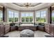 This luxury bathroom features a soaking tub with a view, marble counters, and an ottoman at 833 Hines Rd, Moreland, GA 30259