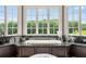 This luxury bathroom features a soaking tub with a view, marble counters, and large windows at 833 Hines Rd, Moreland, GA 30259