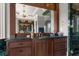 Elegant bathroom vanity with dark wood cabinets, marble countertop, and ornate gold fixtures at 833 Hines Rd, Moreland, GA 30259