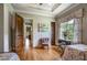 Spacious bedroom with hardwood floors, floral curtains, and decorative chair at 833 Hines Rd, Moreland, GA 30259