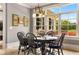 Dining area with a view of the backyard, black table, and natural lighting at 833 Hines Rd, Moreland, GA 30259