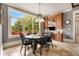 Dining area with a table, wood floors, and a large window overlooking the backyard at 833 Hines Rd, Moreland, GA 30259