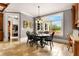 Bright dining area with a large window, black table, and wood cabinets at 833 Hines Rd, Moreland, GA 30259