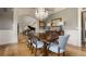 Dining room features a beautiful chandelier, wainscoting, a large table, and views to the foyer and staircase at 833 Hines Rd, Moreland, GA 30259