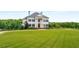 Elegant two-story home with manicured lawn and classic architectural details at 833 Hines Rd, Moreland, GA 30259