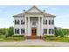 Impressive facade featuring grand columns, stately windows, and manicured landscaping at 833 Hines Rd, Moreland, GA 30259