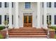 Elegant front entrance with brick steps, stately columns, and a beautiful wood double door at 833 Hines Rd, Moreland, GA 30259