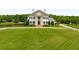 Stunning estate with manicured lawn, stately facade, and circular driveway at 833 Hines Rd, Moreland, GA 30259