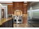 Close up of a kitchen featuring a Wolf range, custom cabinets and stone floors at 833 Hines Rd, Moreland, GA 30259