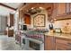 Gourmet kitchen features stainless steel range with custom hood and granite countertops at 833 Hines Rd, Moreland, GA 30259