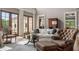 Bright living room with french doors and a tufted leather armchair at 833 Hines Rd, Moreland, GA 30259