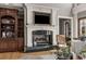 Living room with built-in shelving and a fireplace with decorative mantle at 833 Hines Rd, Moreland, GA 30259