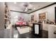 Bright and spacious living room with a ceiling fan, bookshelves, and modern decor at 833 Hines Rd, Moreland, GA 30259