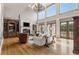 Spacious living room boasts hardwood floors, high ceilings, a fireplace, large windows, and custom built-ins at 833 Hines Rd, Moreland, GA 30259