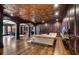 Living room featuring a decorative copper ceiling, wood paneling, and hardwood flooring at 833 Hines Rd, Moreland, GA 30259